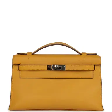 HERMÈS Pre-owned Hermes Kelly Pochette Jaune Ambre Swift Palladium Hardware | Thumbnail 1 HERMÈS Pre-owned Hermes Kelly Pochette Jaune Ambre Swift Palladium Hardware | Thumbnail 1